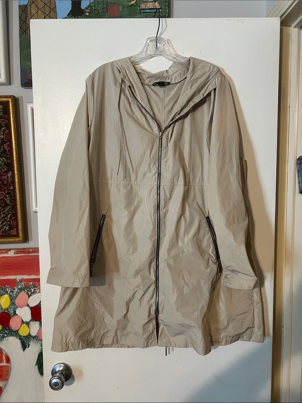 Sun Kim hooded rain jacket. Zip front closure. Zip pockets. A-line